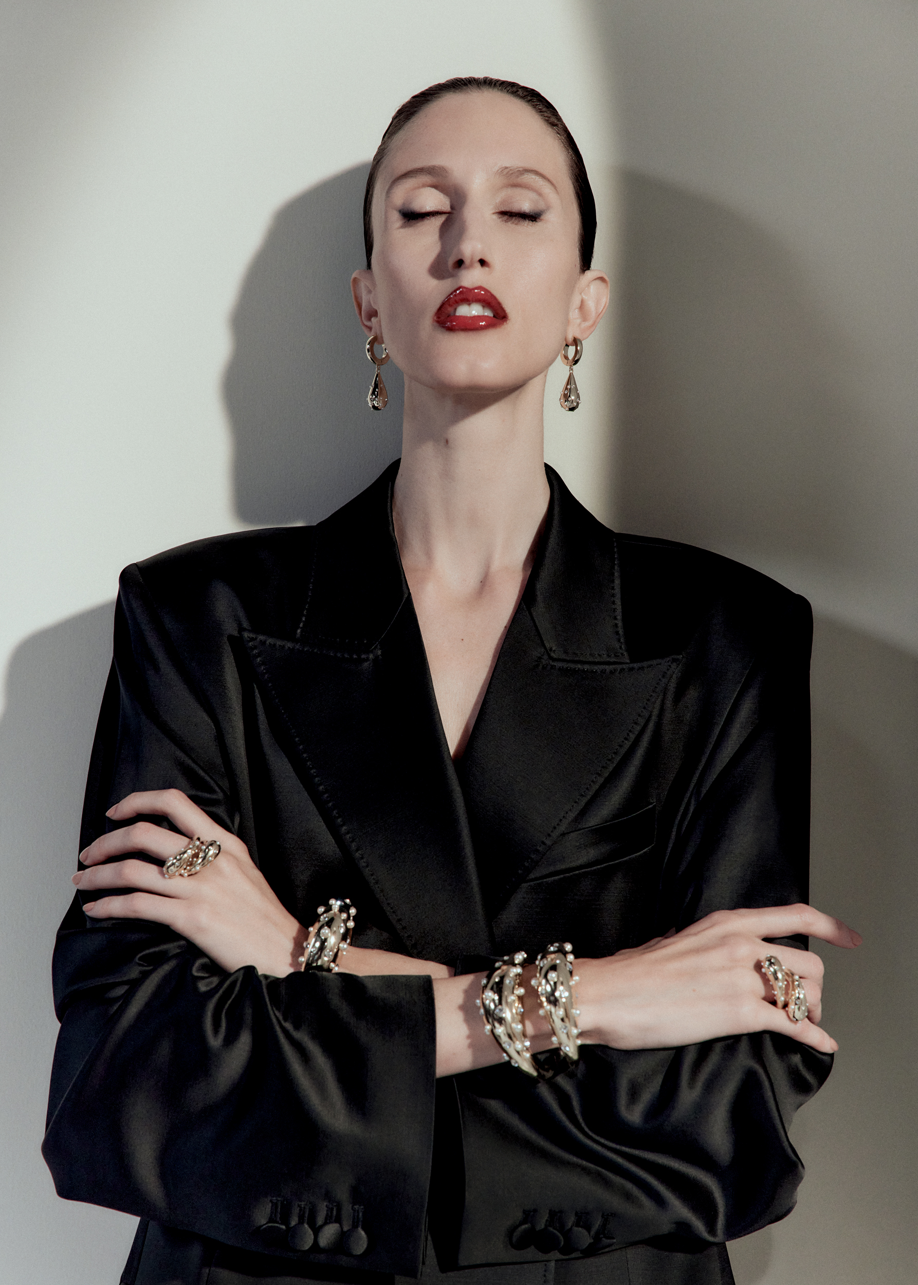 Woman in black blazer and chunky gold jewellery