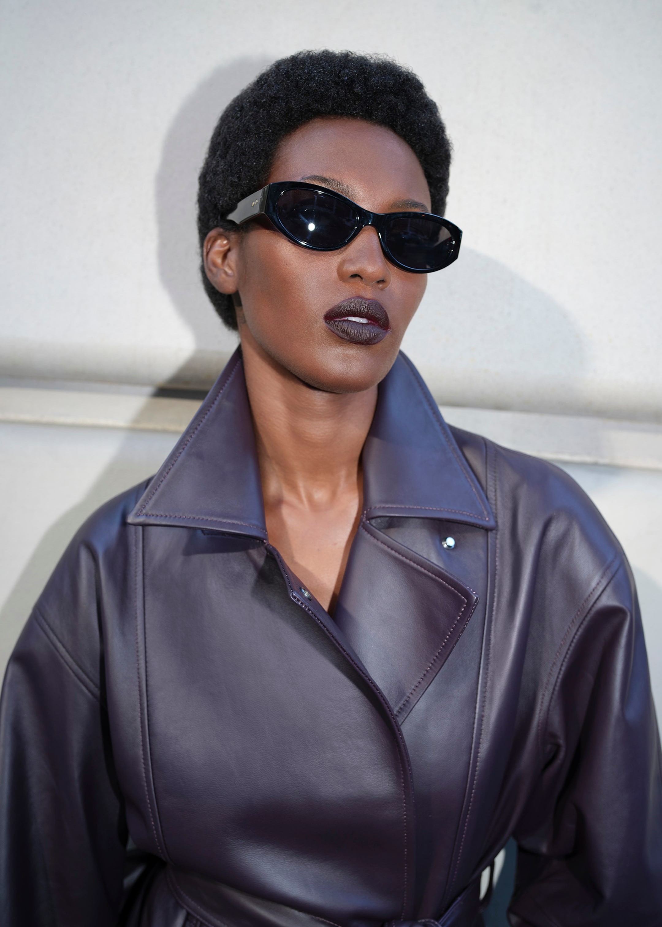 Woman in leather jacket and black sunglasses