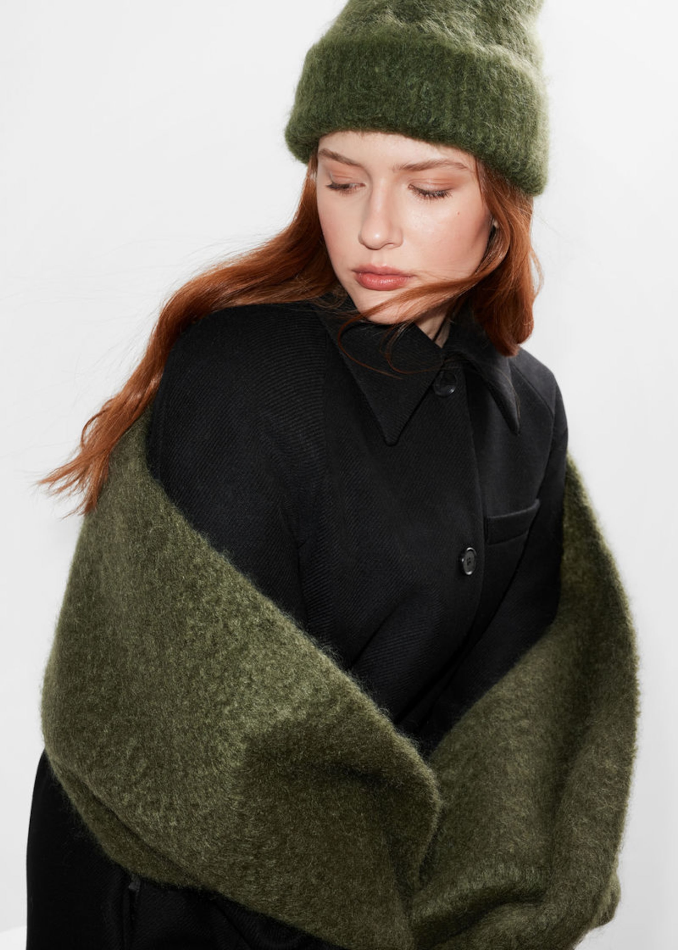 red hair woman wearing green mohair hat and matching scarf around her back