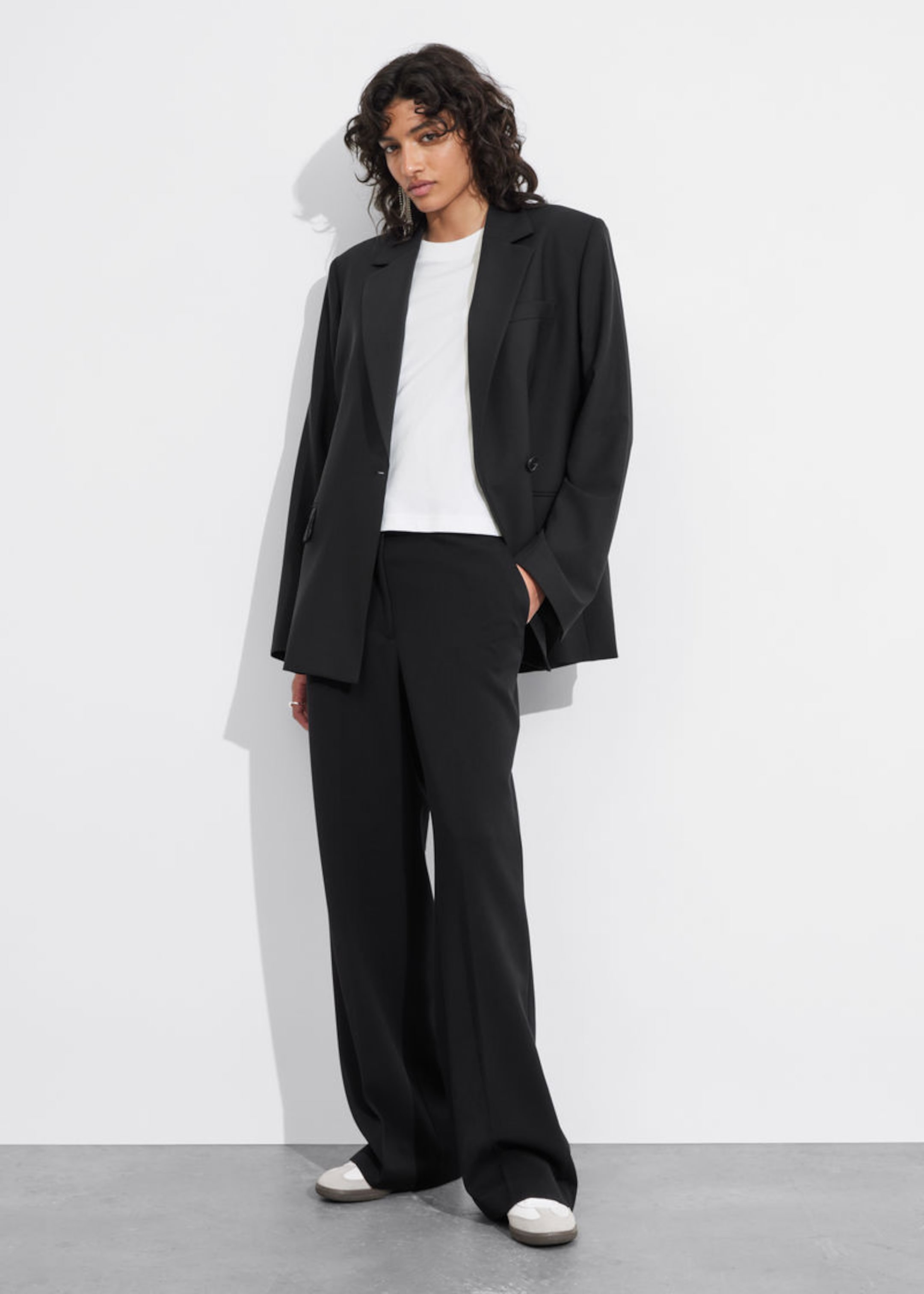 woman in black suit and t-shirt