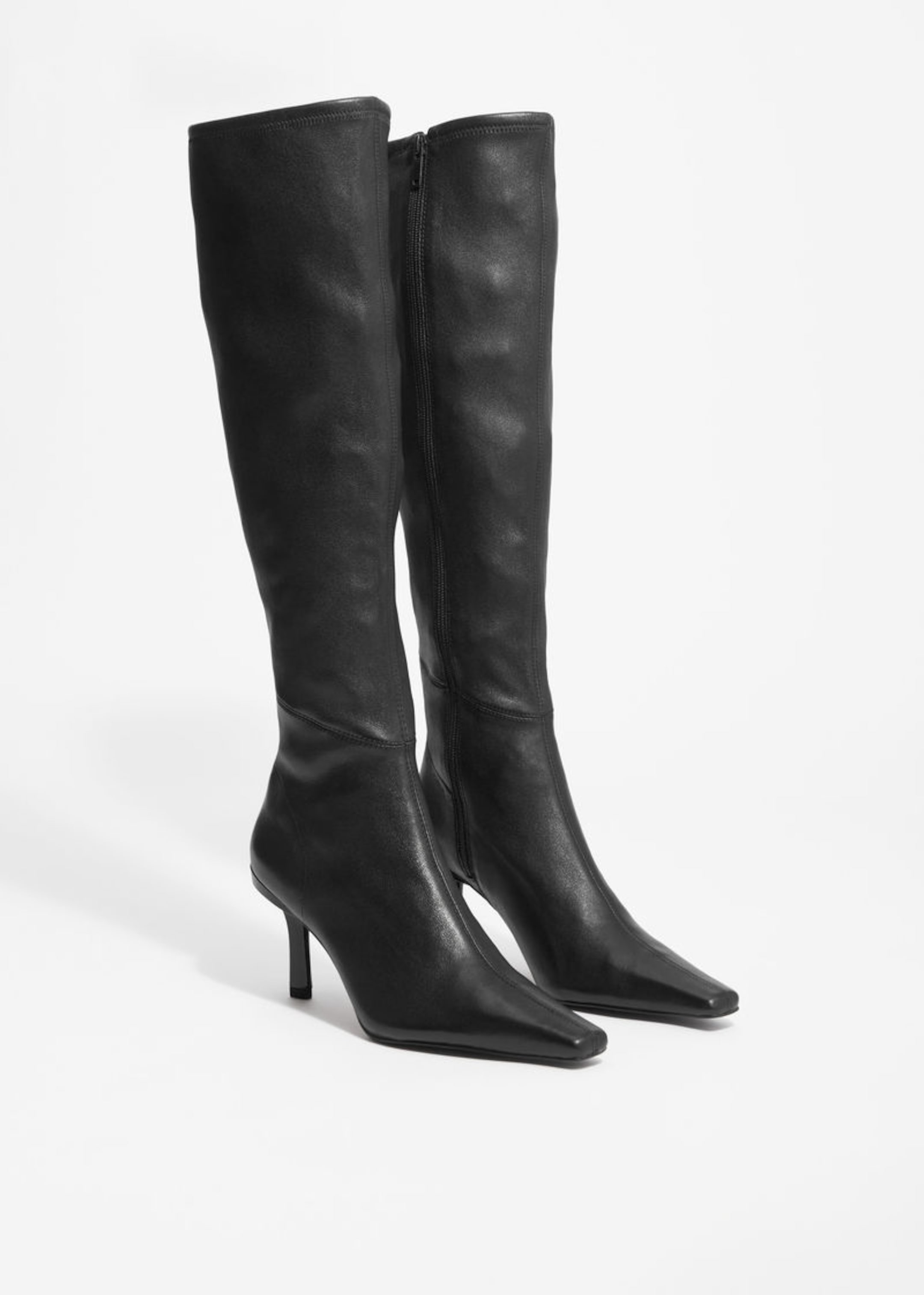 over the knee high heeled leather boots with pointy toe in black